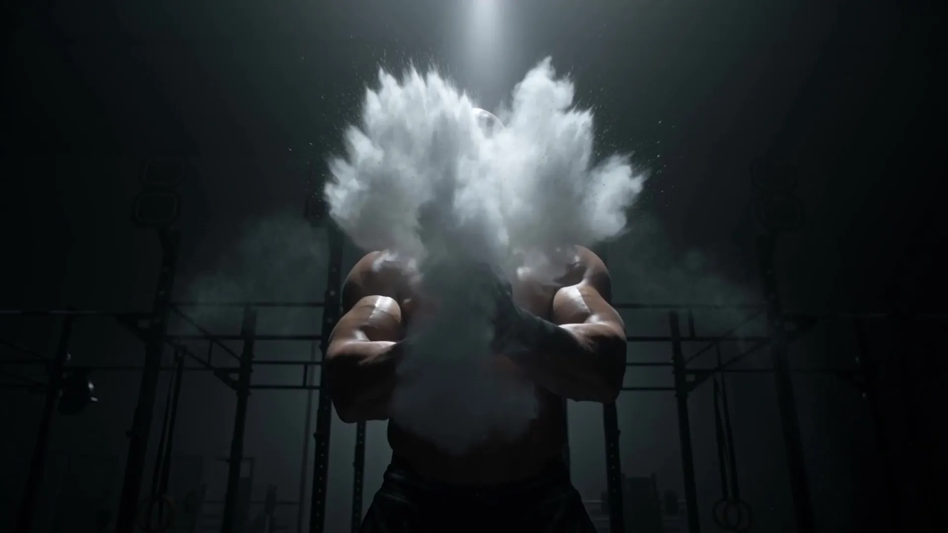 An athlete claps chalk into a white cloud under a single spotlight, a frame from the AI-generated FORGE film