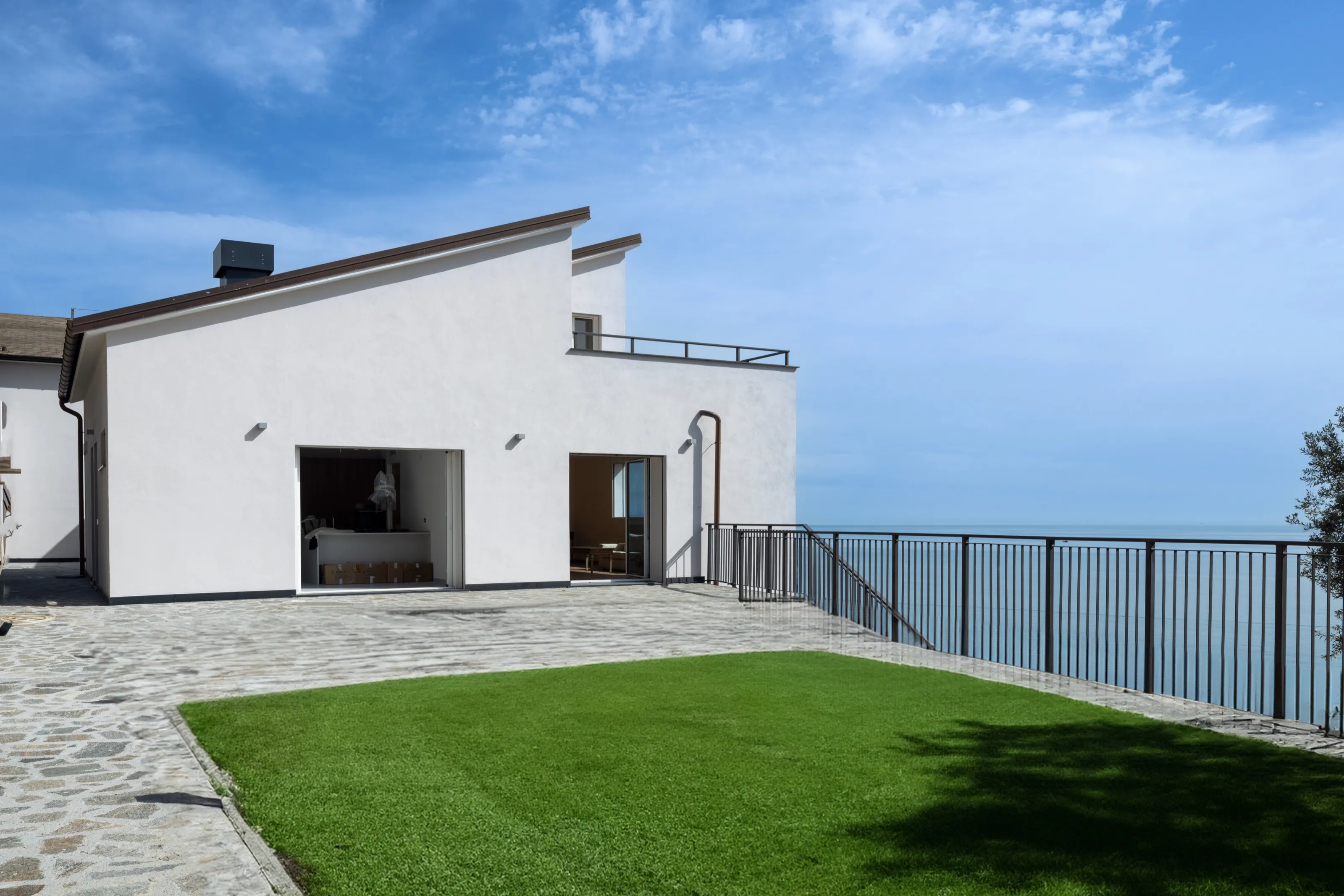The same terrace with a green lawn in place of the bare earth, generated with Adobe Firefly