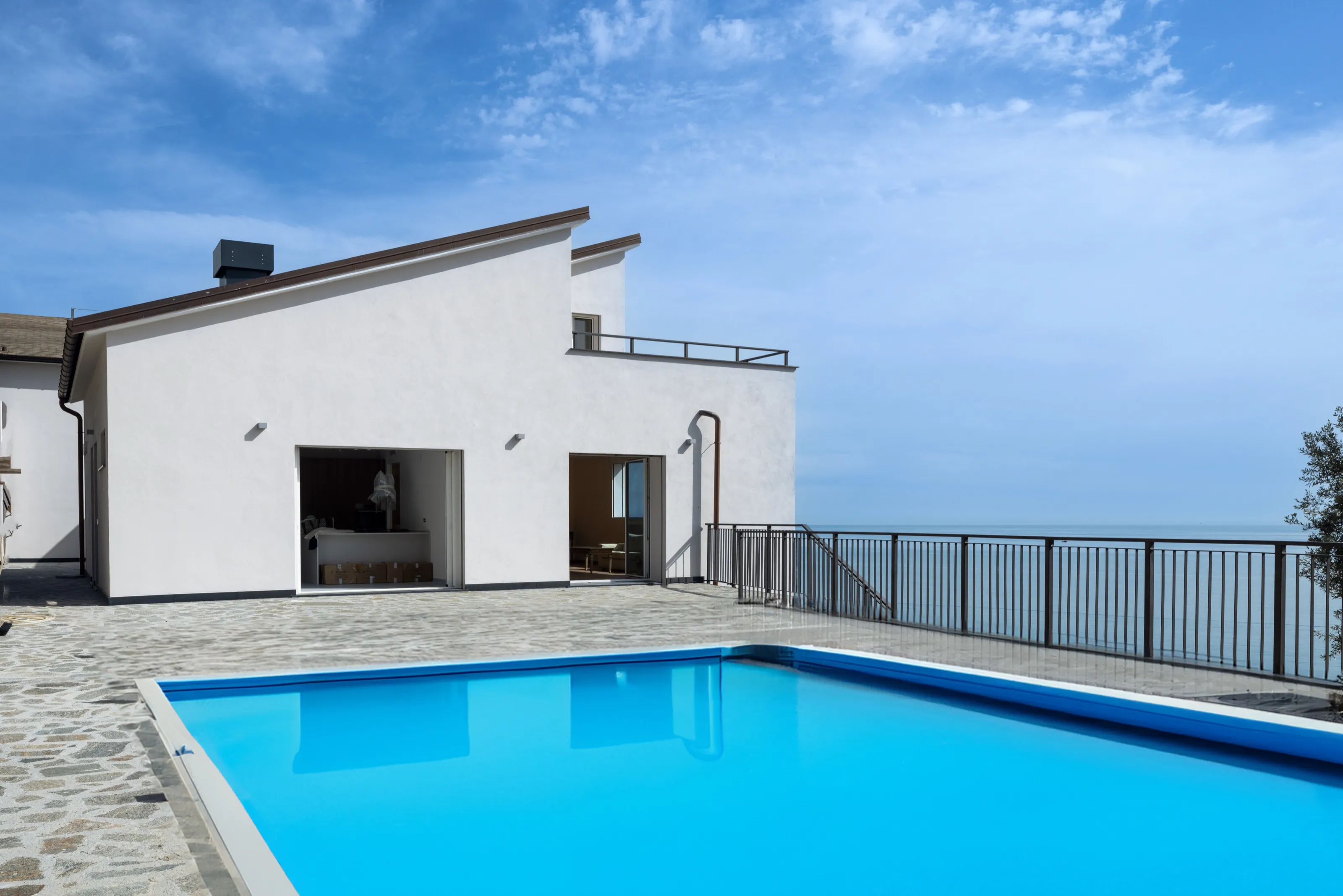 A terrace above the sea with a pool generated with Adobe Firefly