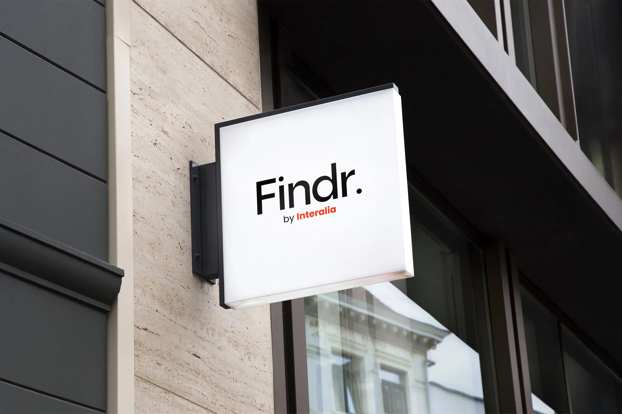 Mockup of a square Findr. by Interalia sign projecting from a travertine wall
