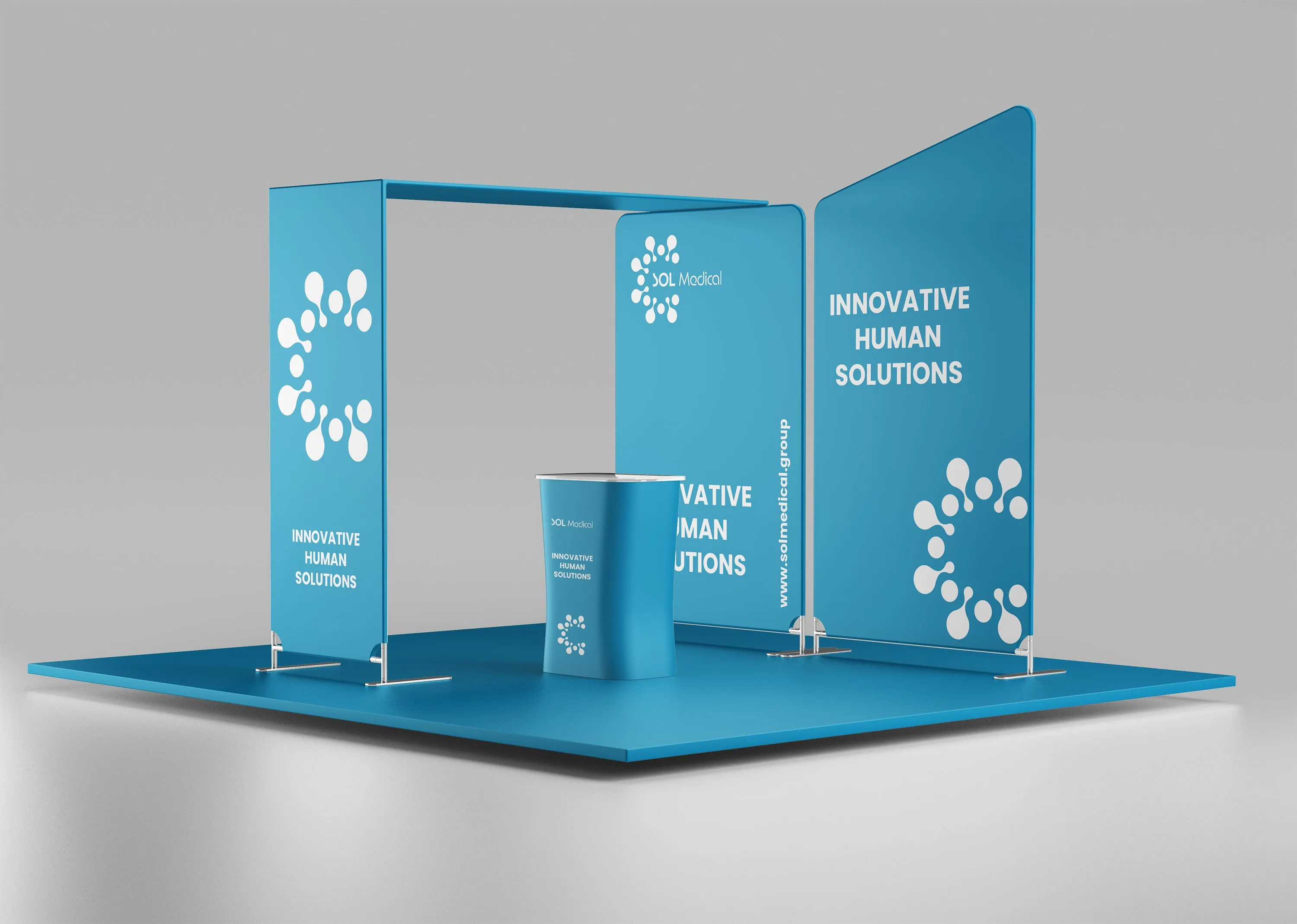 Mockup of the SOL Medical stand on a square cerulean floor: an arch whose front panel carries the white icon and Innovative Human Solutions, two tall panels behind, one with the logo, the same line and www.solmedical.group, the other with the line and the icon, and a curved counter with the name, the line and the icon